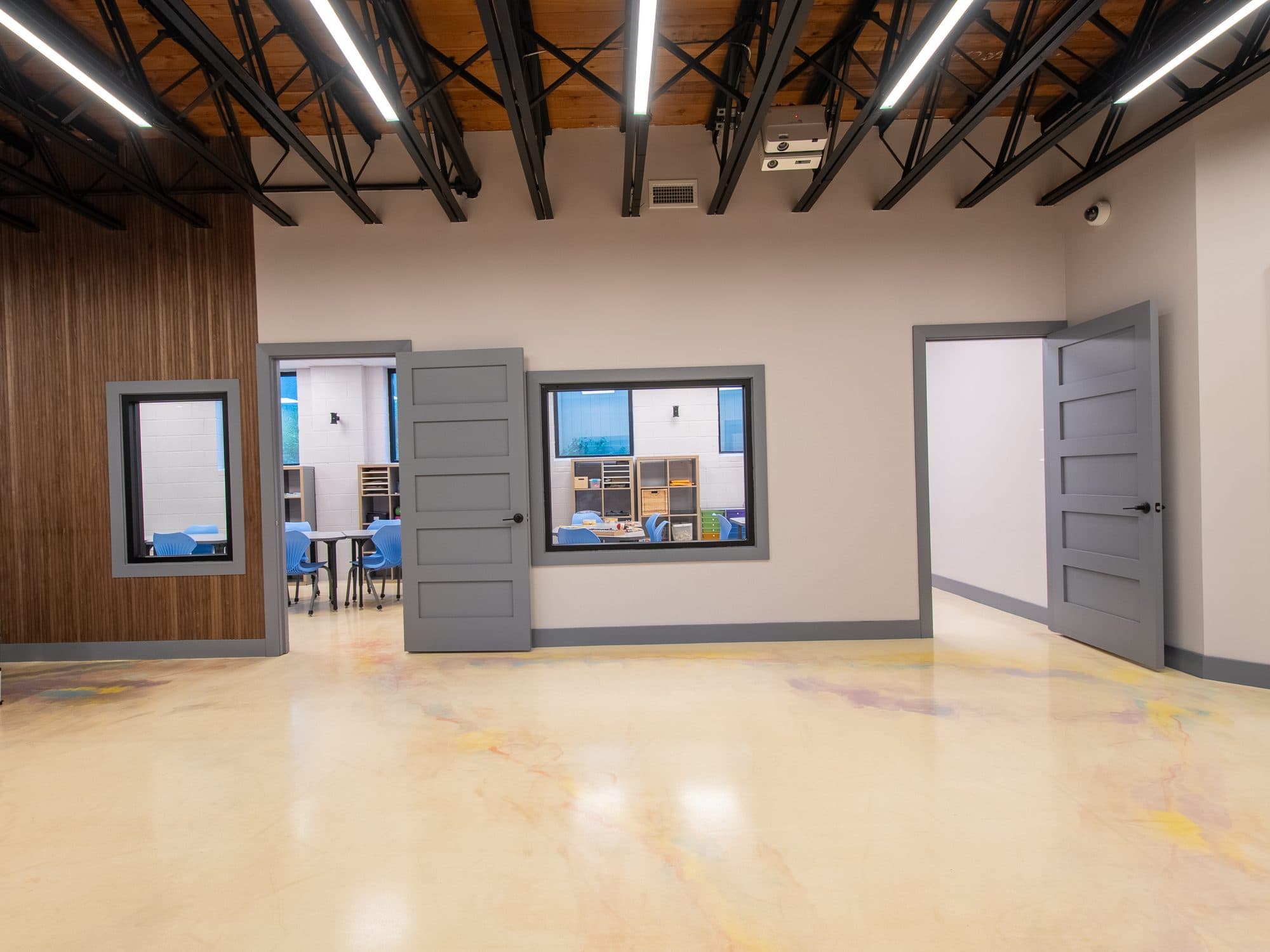 The open main floor at ASun Star's New Jersey headquarters, with therapy rooms along one side and a mural at the far end.